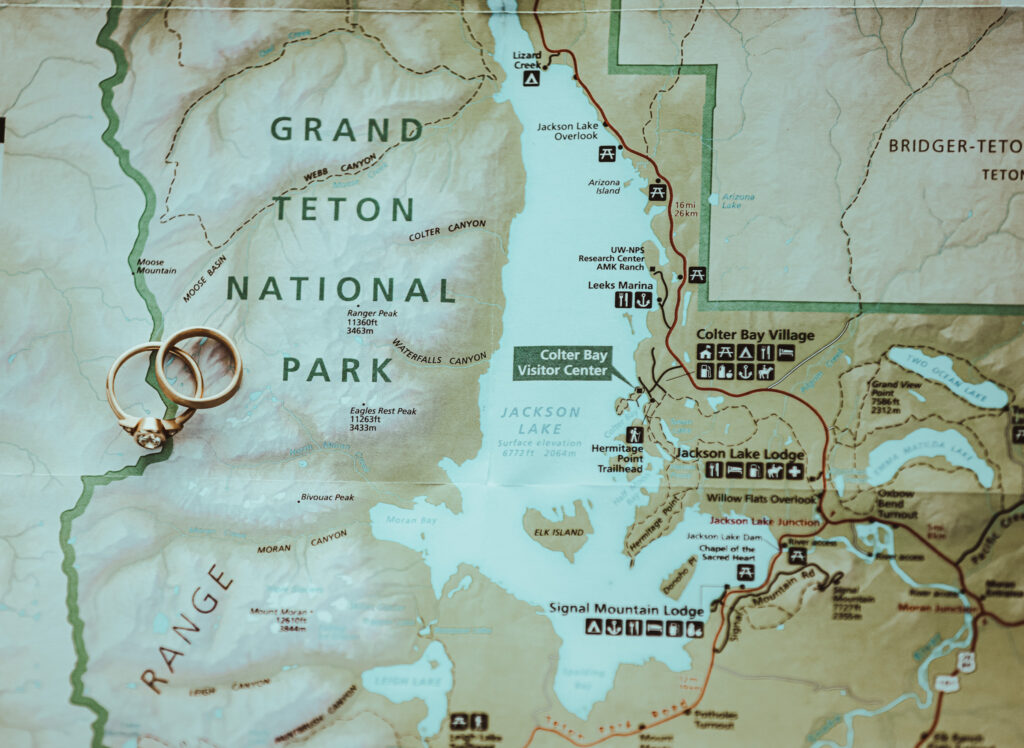 Lesbian rings on a map of Grand Teton National Park after the surprise proposal.