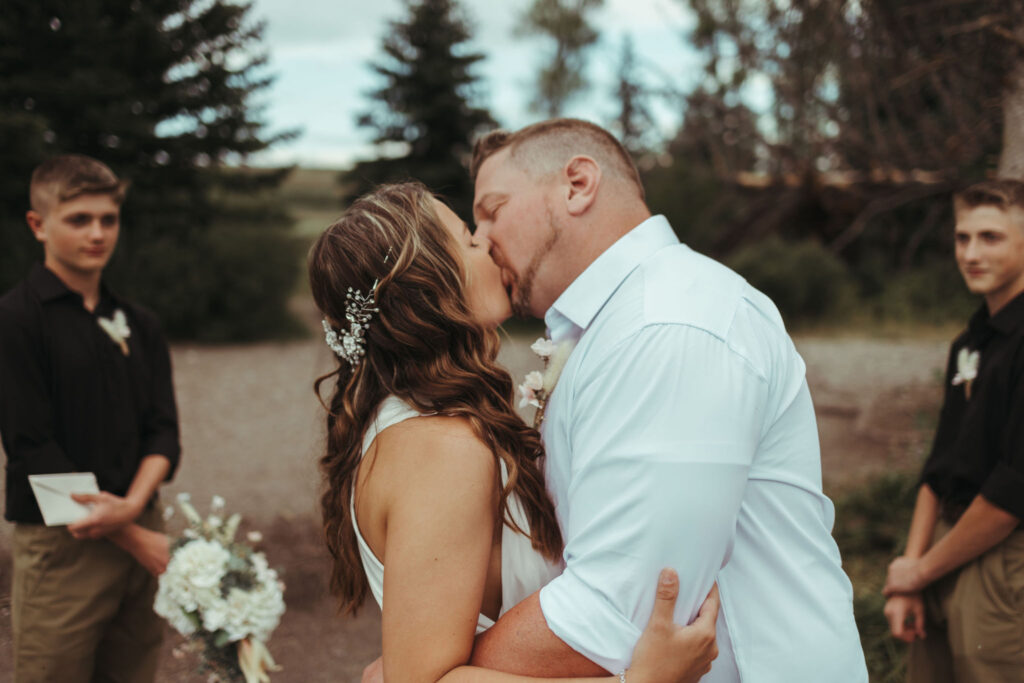 Bride and groom kiss at Schwabacher Landing elopement