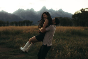Scenes from Grand Teton engagement session of a playful couple at Mormon Row, taken by Elayna RaNae Photo and Film who is a Jackson Hole videographer.