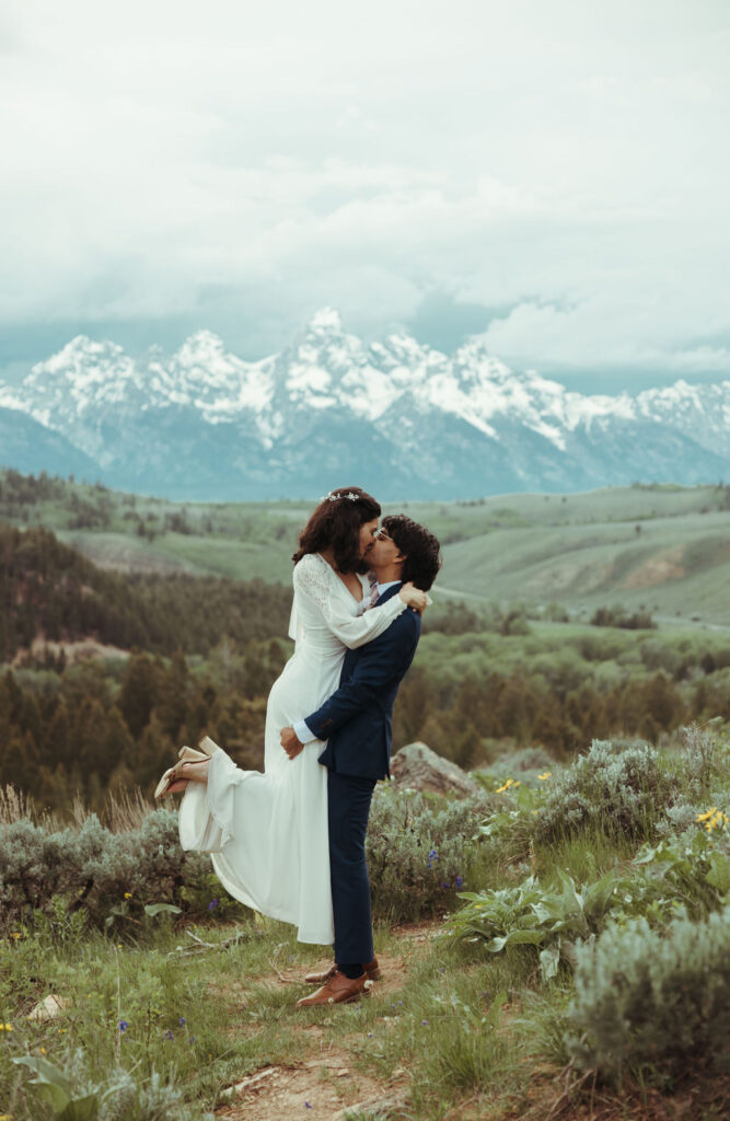 couple celebrating at the wedding tree in jackson hole